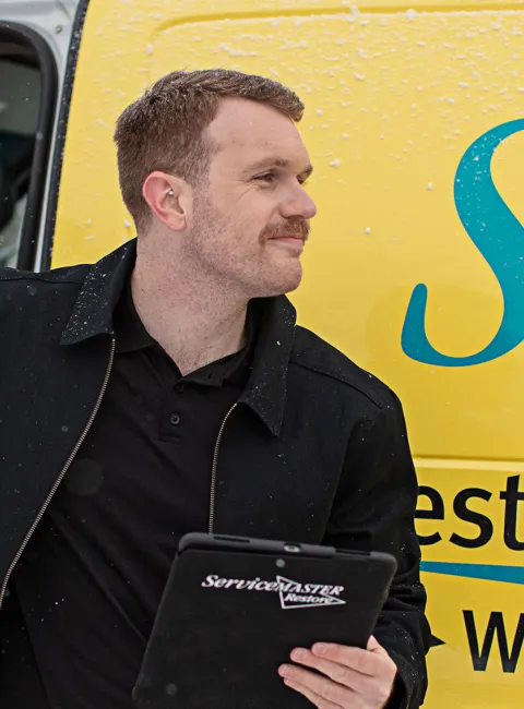 Respond Property Solutions technician stepping out of a branded company van