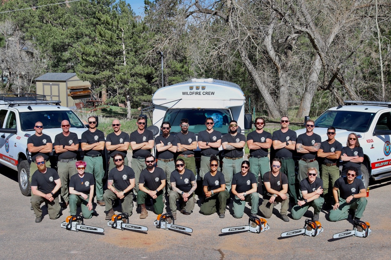 Emergency response crew assessing wildfire or storm damage to a US structure