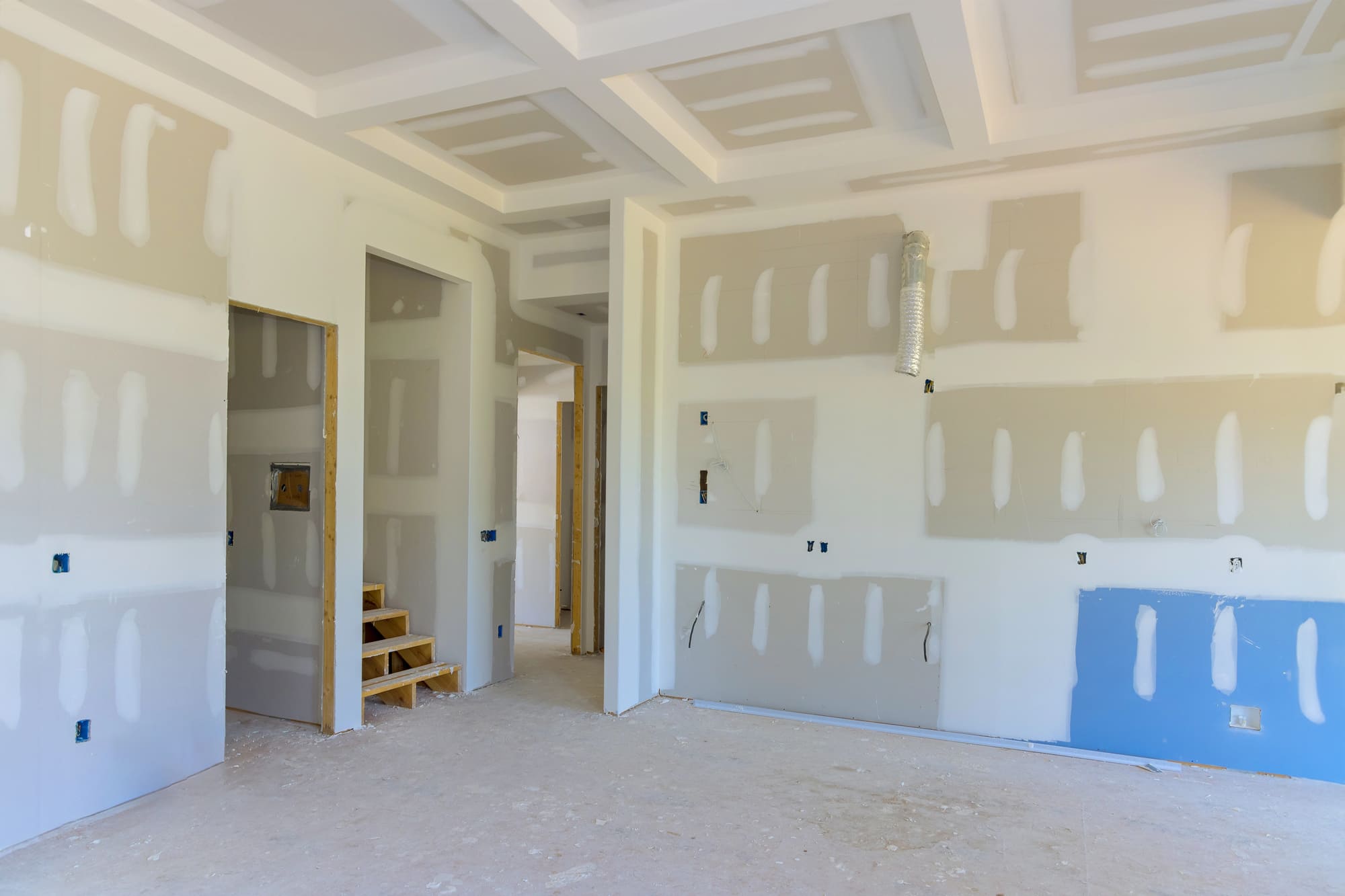 Restoration construction crew rebuilding interior walls in a fire-damaged US home